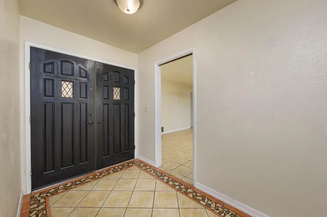 an empty room with fireplace and windows