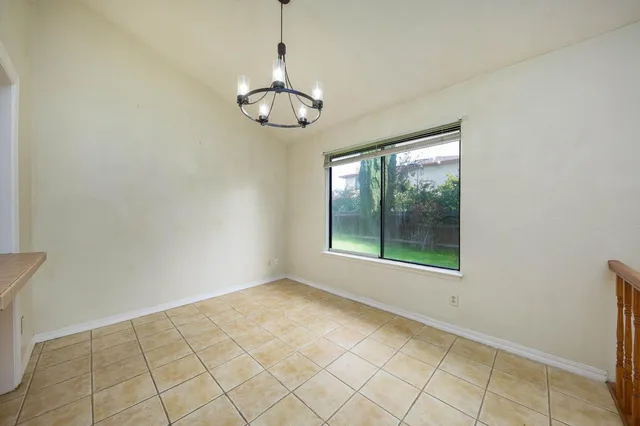 a view of a kitchen with furniture and a ceiling fan