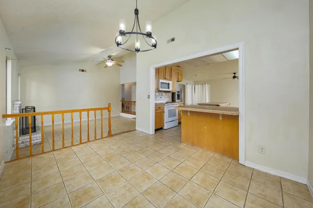 a view of a kitchen with refrigerator and windows