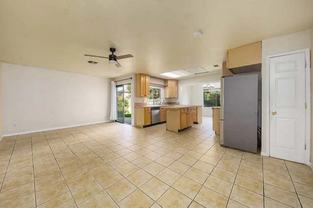 a kitchen with a sink a counter top space stainless steel appliances and cabinets