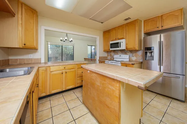 a kitchen with a stove and a refrigerator