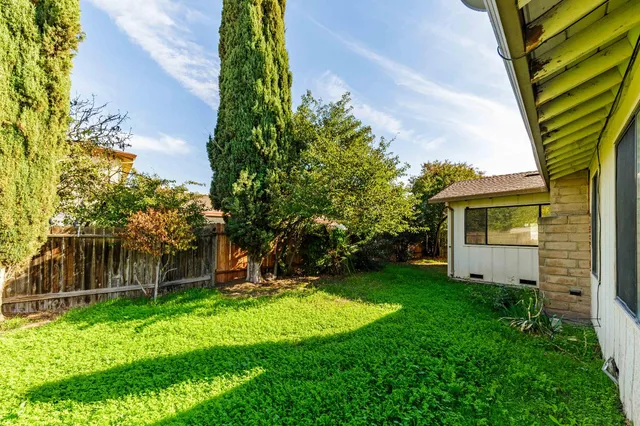 a view of a house with a backyard