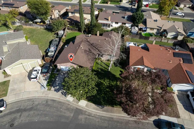 an aerial view of a house with a yard