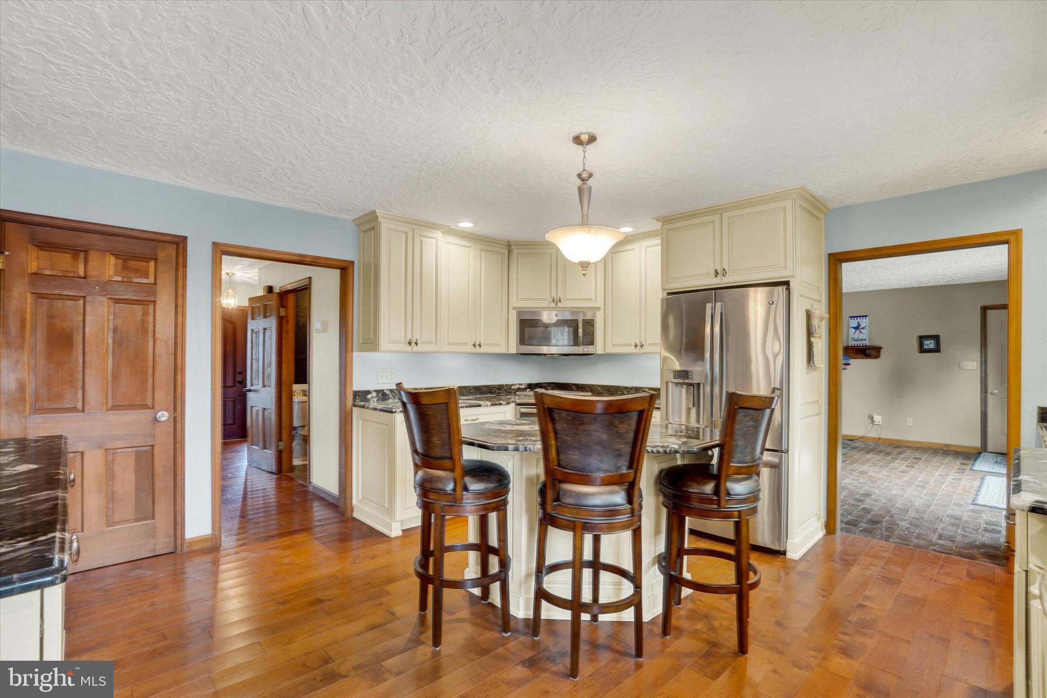 441 School Road York, PA 17407 - Photo 12 of 34 a kitchen with stainless steel appliances a dining table chairs refrigerator and sink