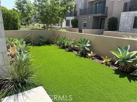 a view of a swimming pool with a garden and trees