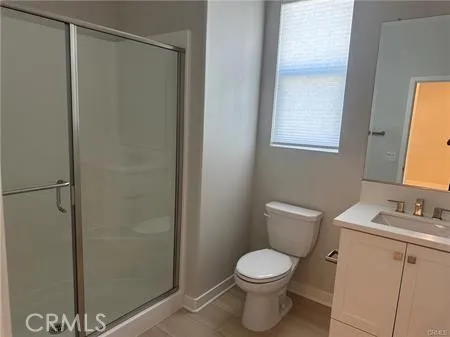 a white toilet sitting next to a bathroom sink