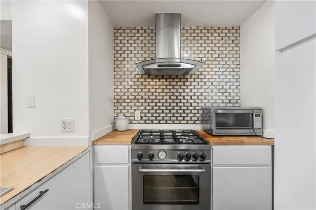 a stove top oven sitting inside of a kitchen
