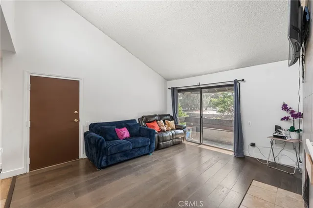 a living room with furniture toys and a flat screen tv