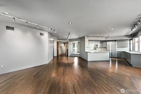 a view of a kitchen with cabinets and wooden floor