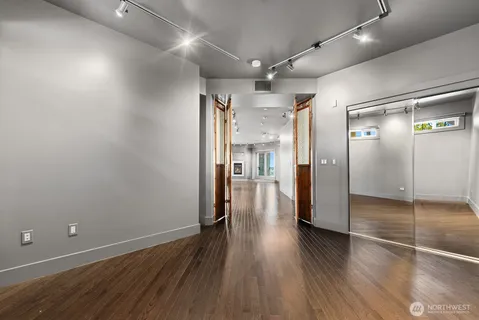a view of a hallway with wooden floor