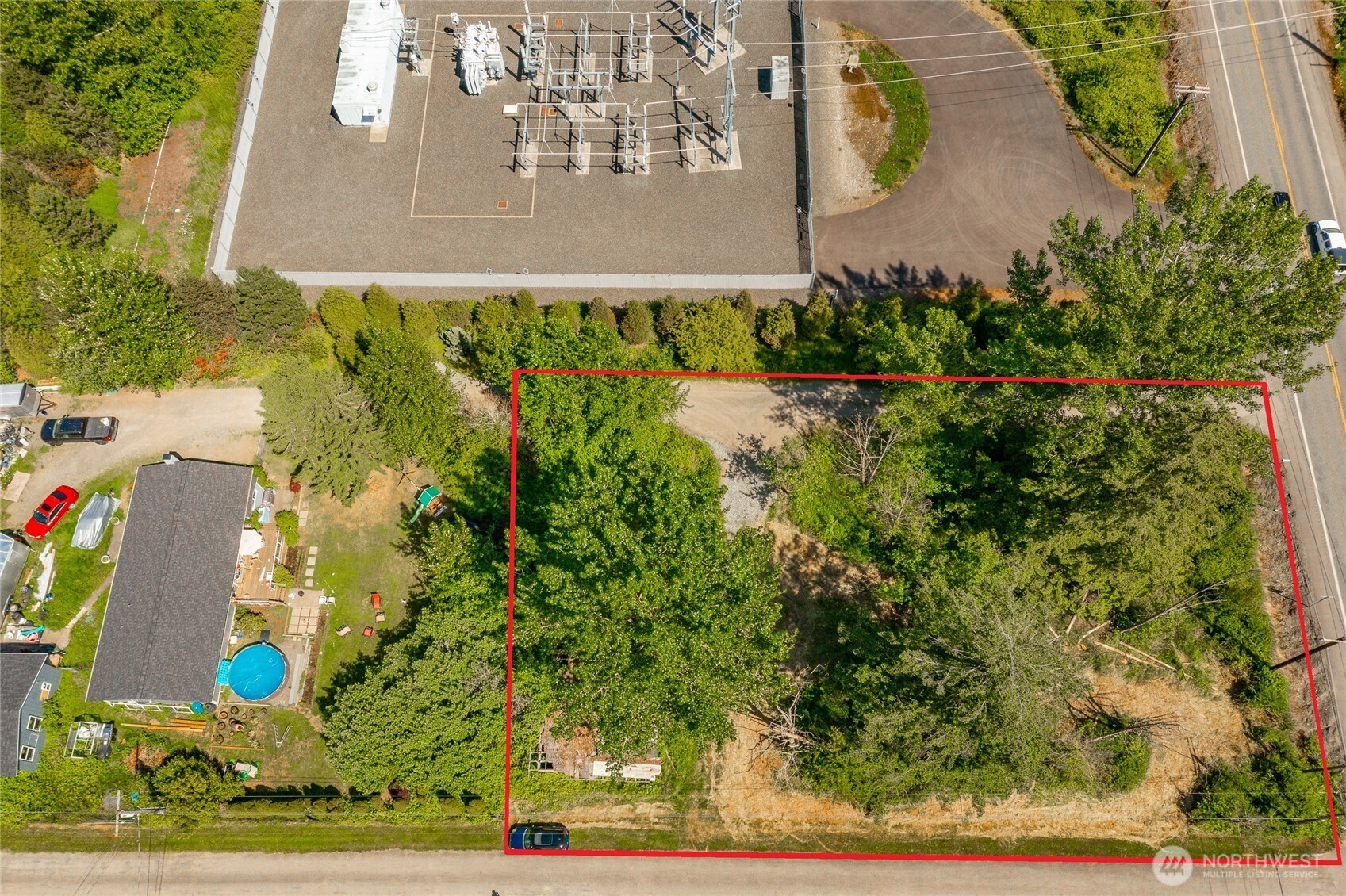 an aerial view of a residential houses with yard