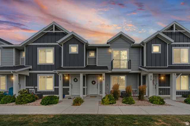 878 North Old Rnch Road Lehi, UT 84048 - Photo 1 of 36 Modern townhome exteriors featuring horizontal and vertical siding, white trim accents, and individual entryways