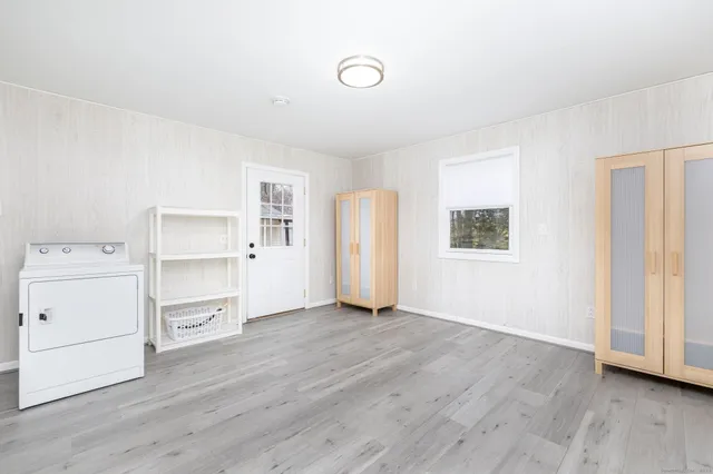 a view of a room with wooden floor and window