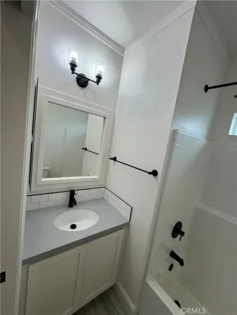 a bathroom with a sink and mirror