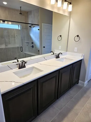 a bathroom with a double vanity sink and mirror