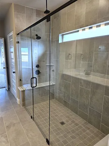 a bathroom with a shower and a mirror