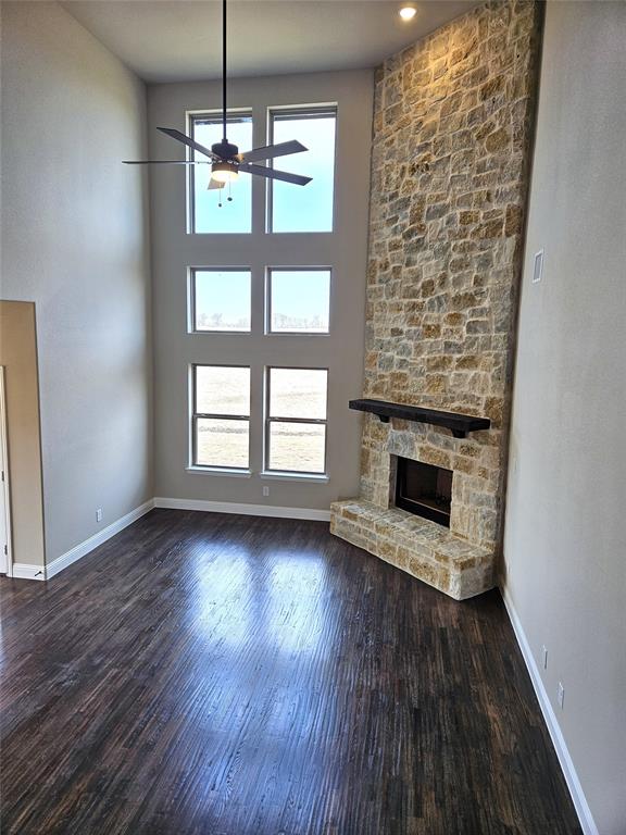 1429 Enloe Road Howe, TX 75459 - Photo 4 of 19 an empty room with wooden floor fireplace and windows