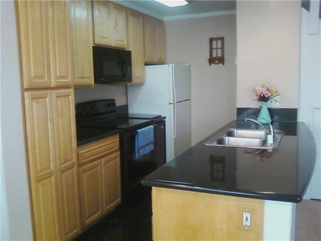 9906 Mission Vega Road, Unit 3 Santee, CA 92071 - Photo 2 of 8 Really nice updated kitchen with pull-out drawers on rollers, a wine refrigerator and a regular refrigerator, stack washer and dryer, garbage disposal, range, microwave, granite counter tops.