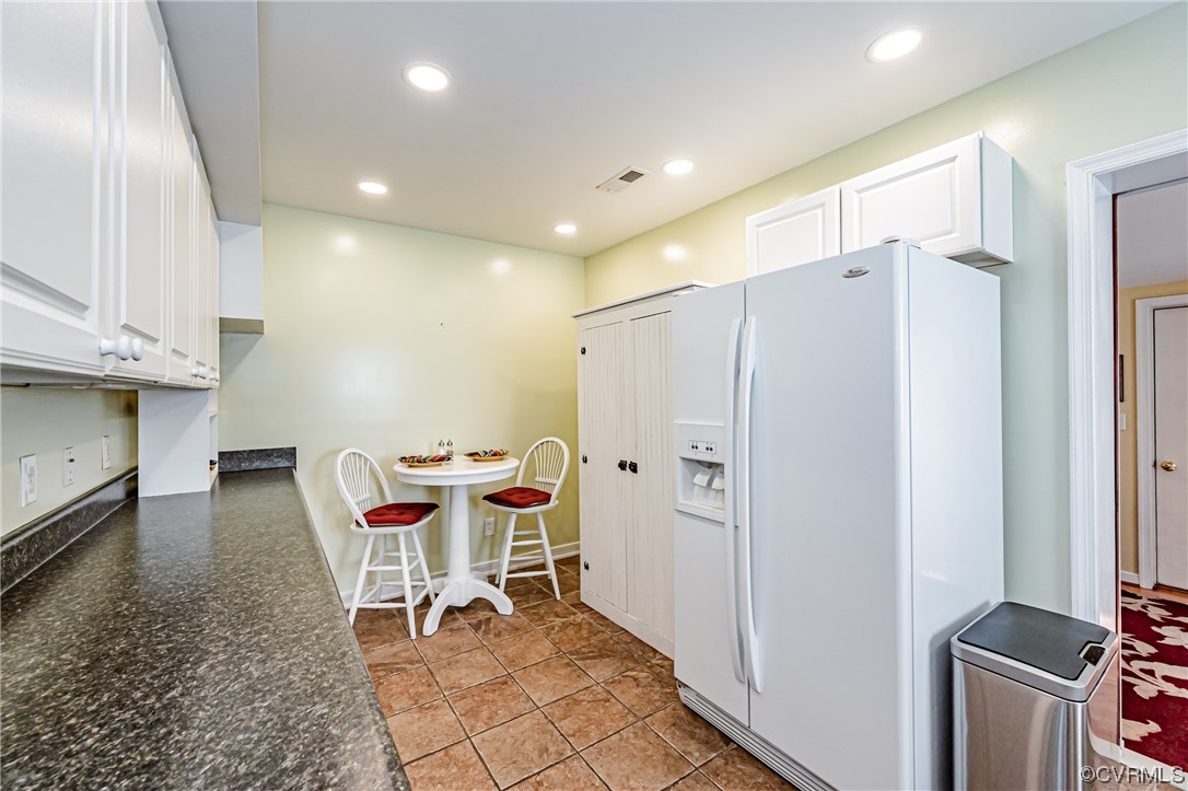 110 Hampton Road Dunnsville, VA 22454 - Photo 19 of 50 a dining room with stainless steel appliances a refrigerator and furniture