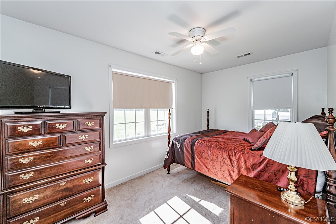 110 Hampton Road Dunnsville, VA 22454 - Photo 29 of 50 a spacious bedroom with a bed and a flat screen tv