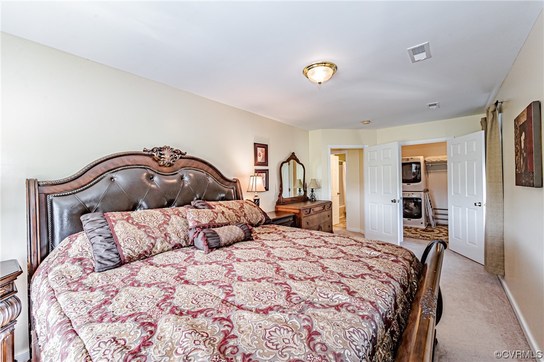 110 Hampton Road Dunnsville, VA 22454 - Photo 40 of 50 a bedroom with a bed and a large mirror