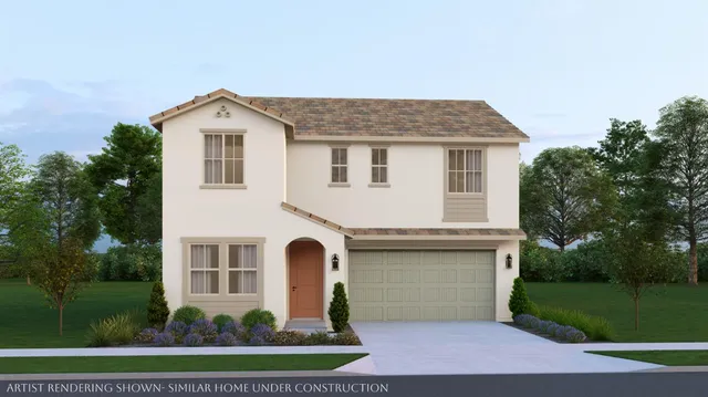 a front view of a house with a yard and trees