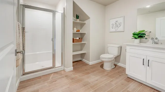 a bathroom with a toilet a sink and a window