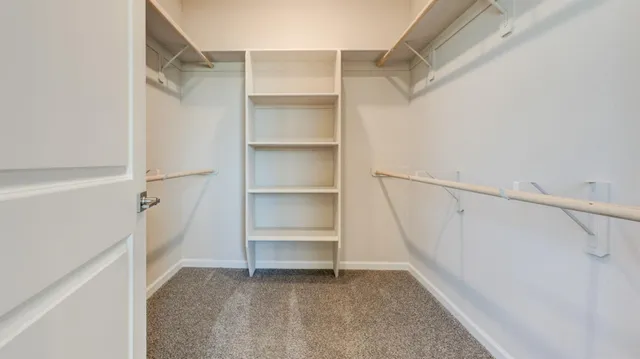 a view of walk in closet with empty racks