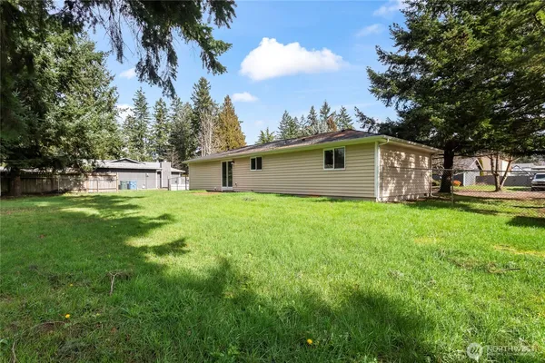a view of a house with a backyard