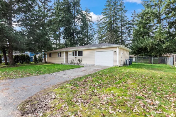 a view of house with backyard
