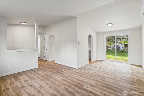 wooden floor in an empty room with a window