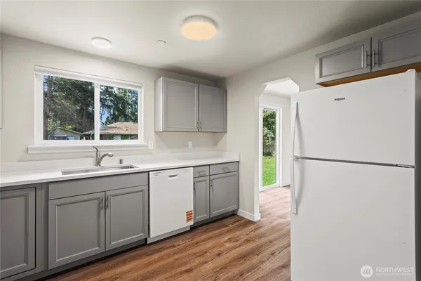 a kitchen with a sink a refrigerator and window