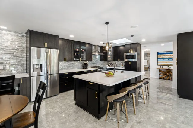 a kitchen with a table chairs stove and kitchen view