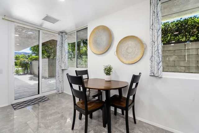 a view of a chairs and table in backyard