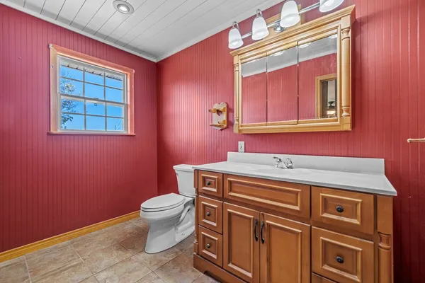 a bathroom with a sink a toilet and mirror