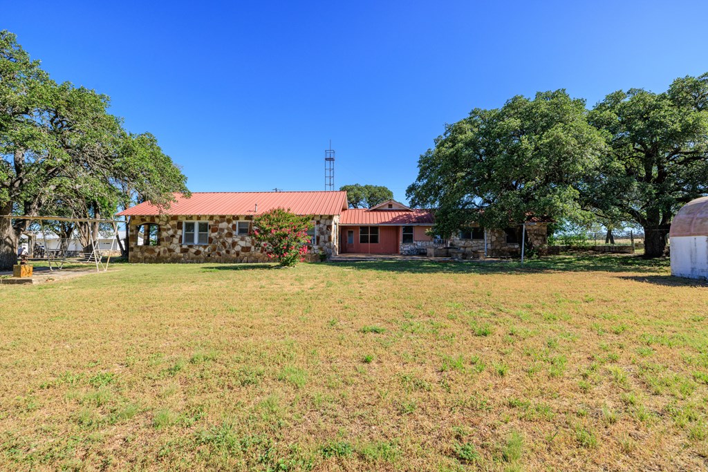 315 Rieger Road Harper, TX 78631 - Photo 9 of 30 a front view of a building with large trees