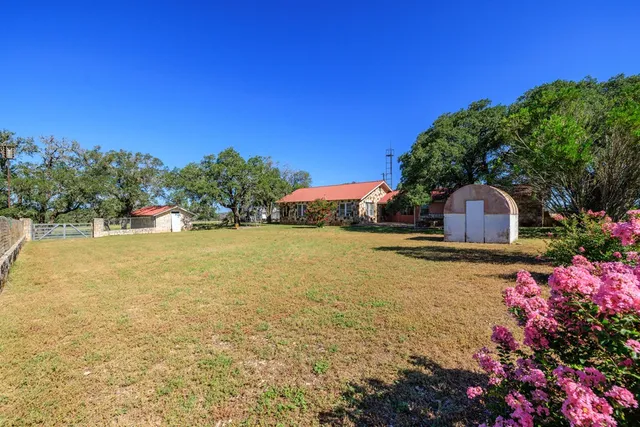 a front view of house with yard and swimming pool