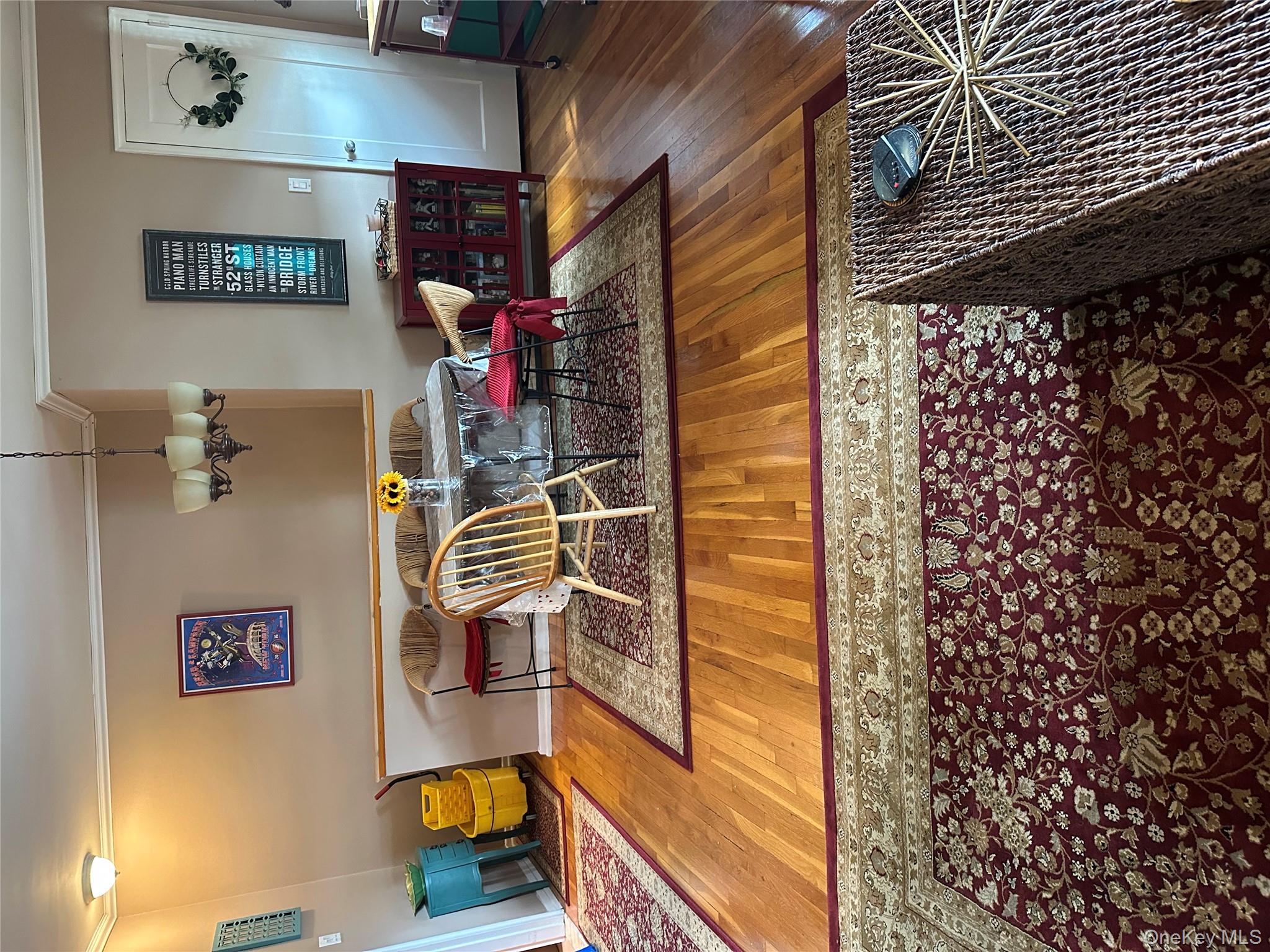 81-49 268th Street, Unit 290B Queens, NY 11004 - Photo 3 of 9 a bedroom with furniture and a rug