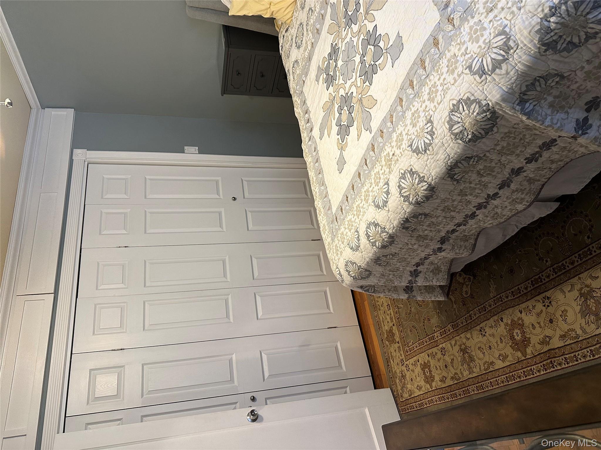 81-49 268th Street, Unit 290B Queens, NY 11004 - Photo 8 of 9 a bedroom with a bed and curtain