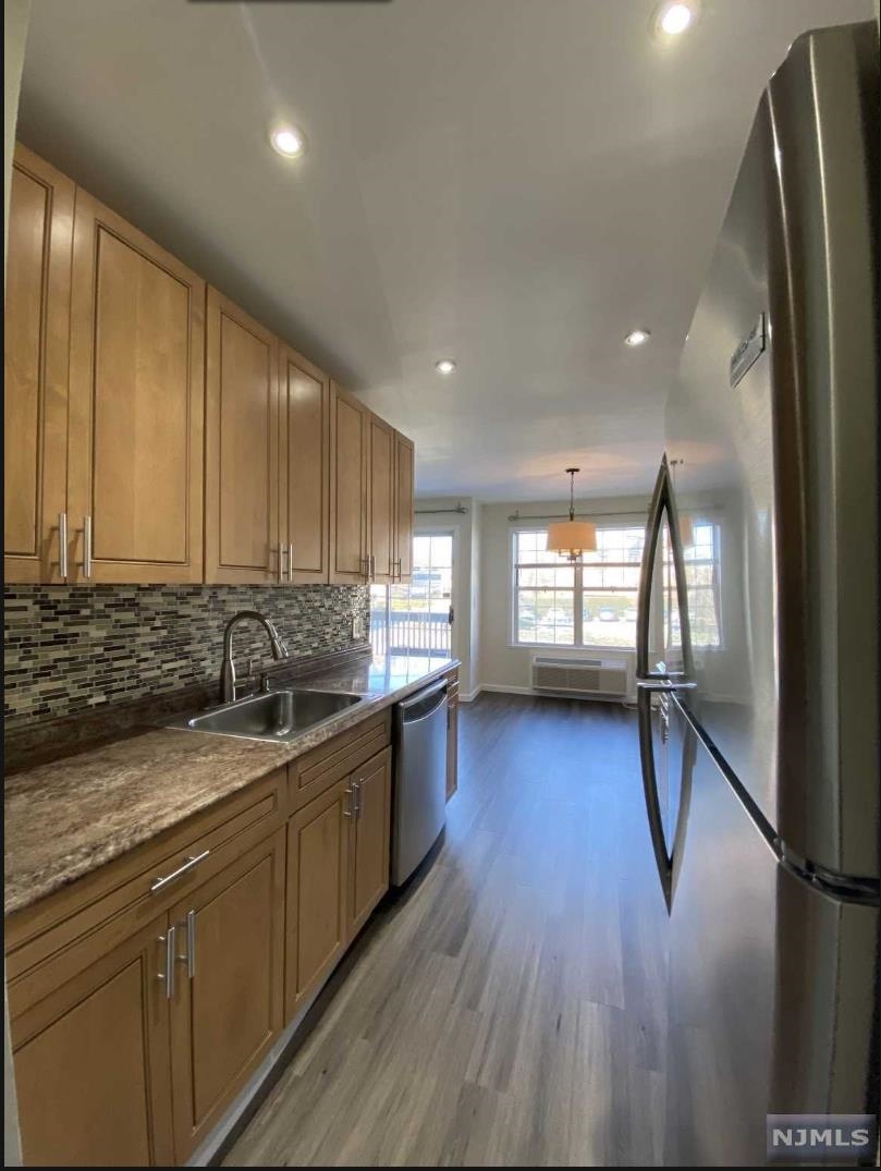 280 Kipp Street, Unit 2A Hackensack, NJ 07601 - Photo 10 of 12 a kitchen with a sink window and cabinets