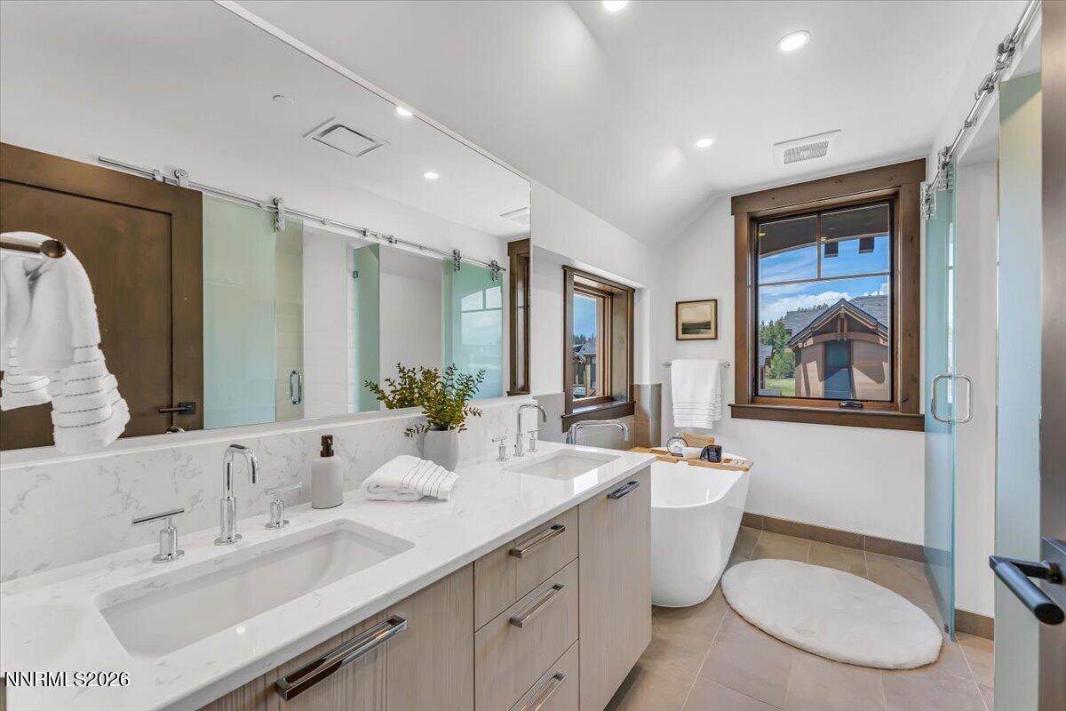 46 Beach Club Drive, Unit 905 Stateline, NV 89449 - Photo 19 of 37 a bathroom with a double vanity sink toilet and a mirror