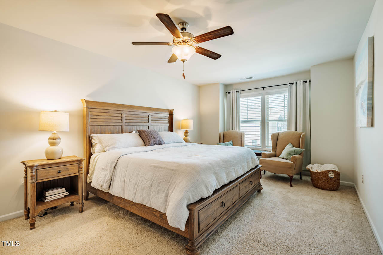 1101 Compass Drive Durham, NC 27713 - Photo 12 of 32 a bedroom with a bed and a chandelier