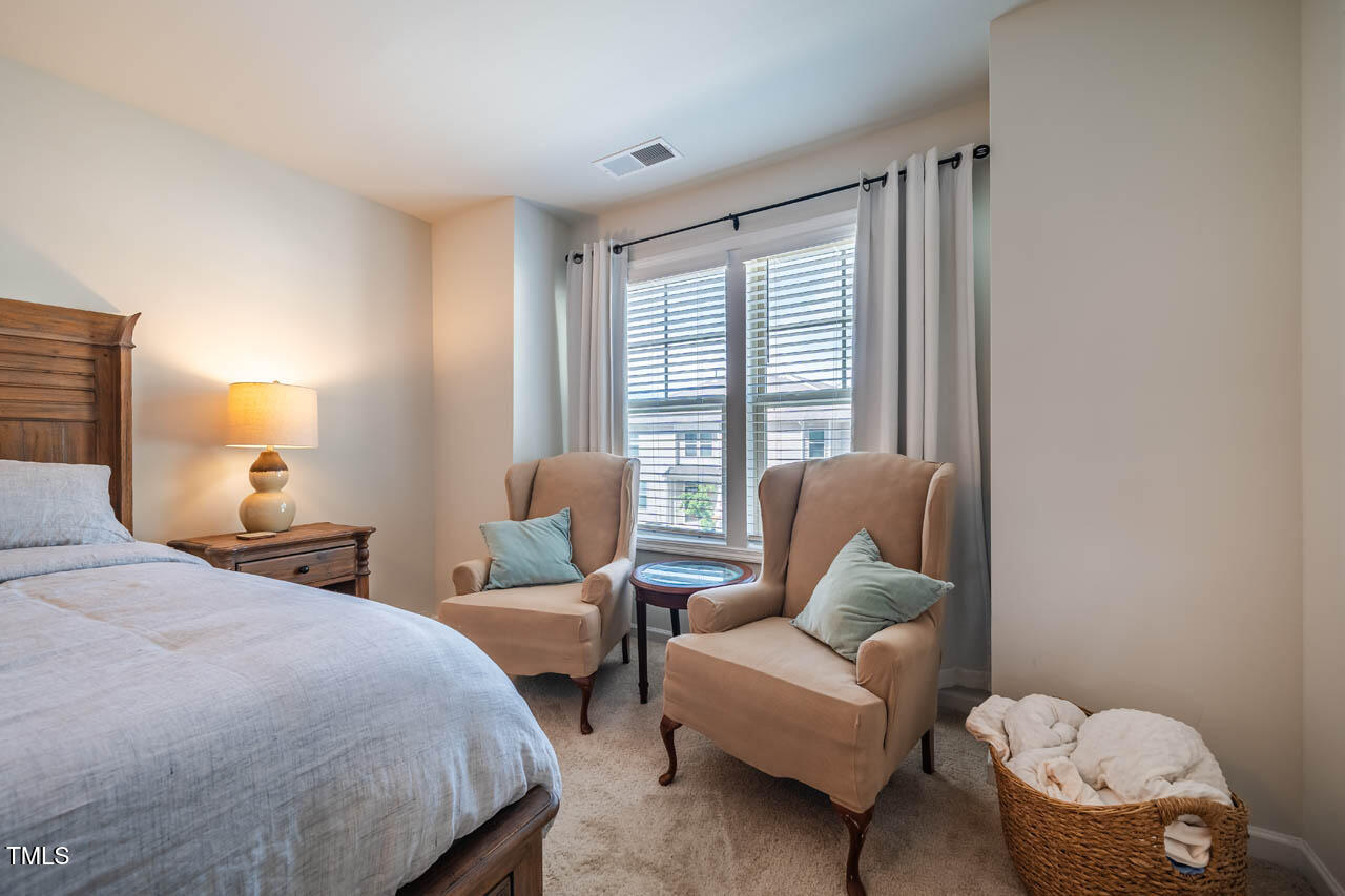 1101 Compass Drive Durham, NC 27713 - Photo 15 of 32 a bedroom with a bed and a couch