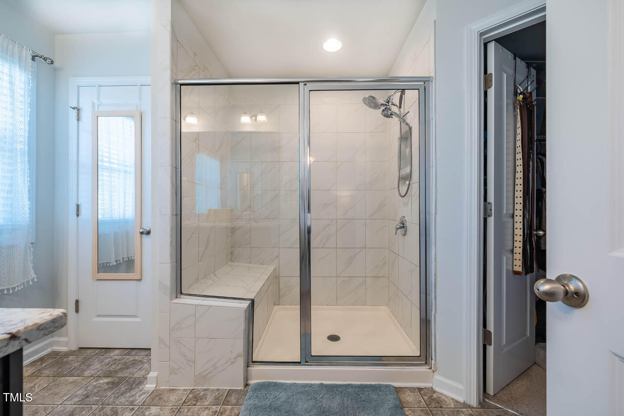 1101 Compass Drive Durham, NC 27713 - Photo 16 of 32 a bathroom with a glass shower door