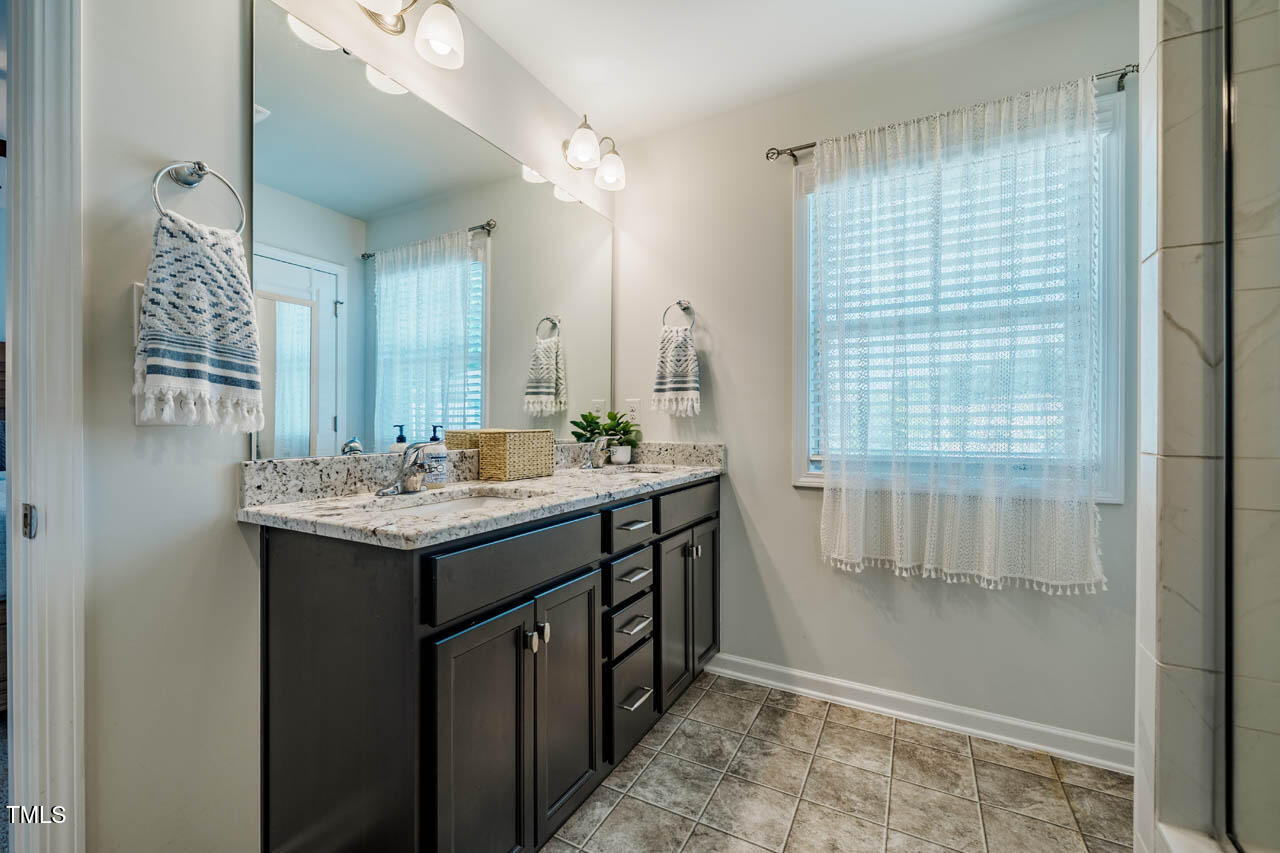 1101 Compass Drive Durham, NC 27713 - Photo 17 of 32 a bathroom with a granite countertop sink and a mirror