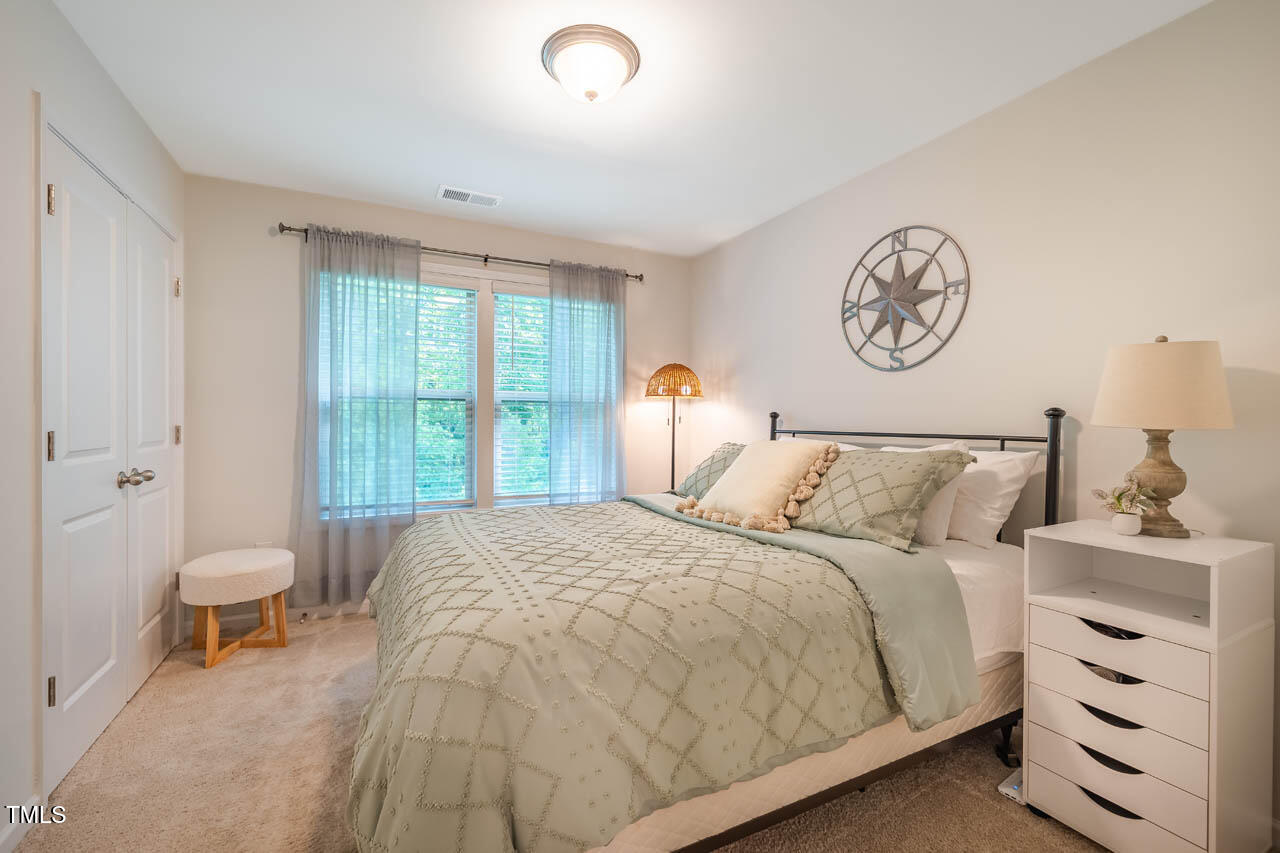 1101 Compass Drive Durham, NC 27713 - Photo 21 of 32 a bedroom with a bed and a window