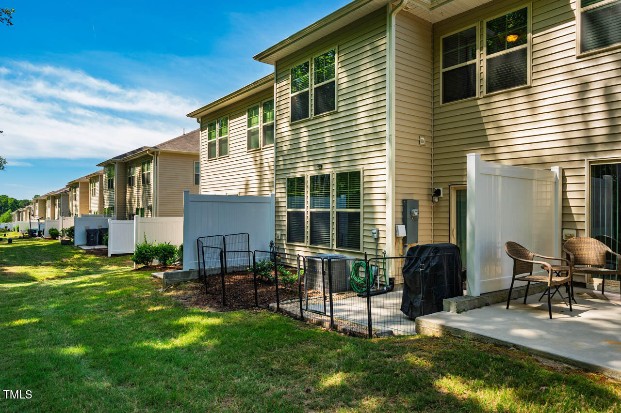 1101 Compass Drive Durham, NC 27713 - Photo 29 of 32 a view of a house with a yard and chairs