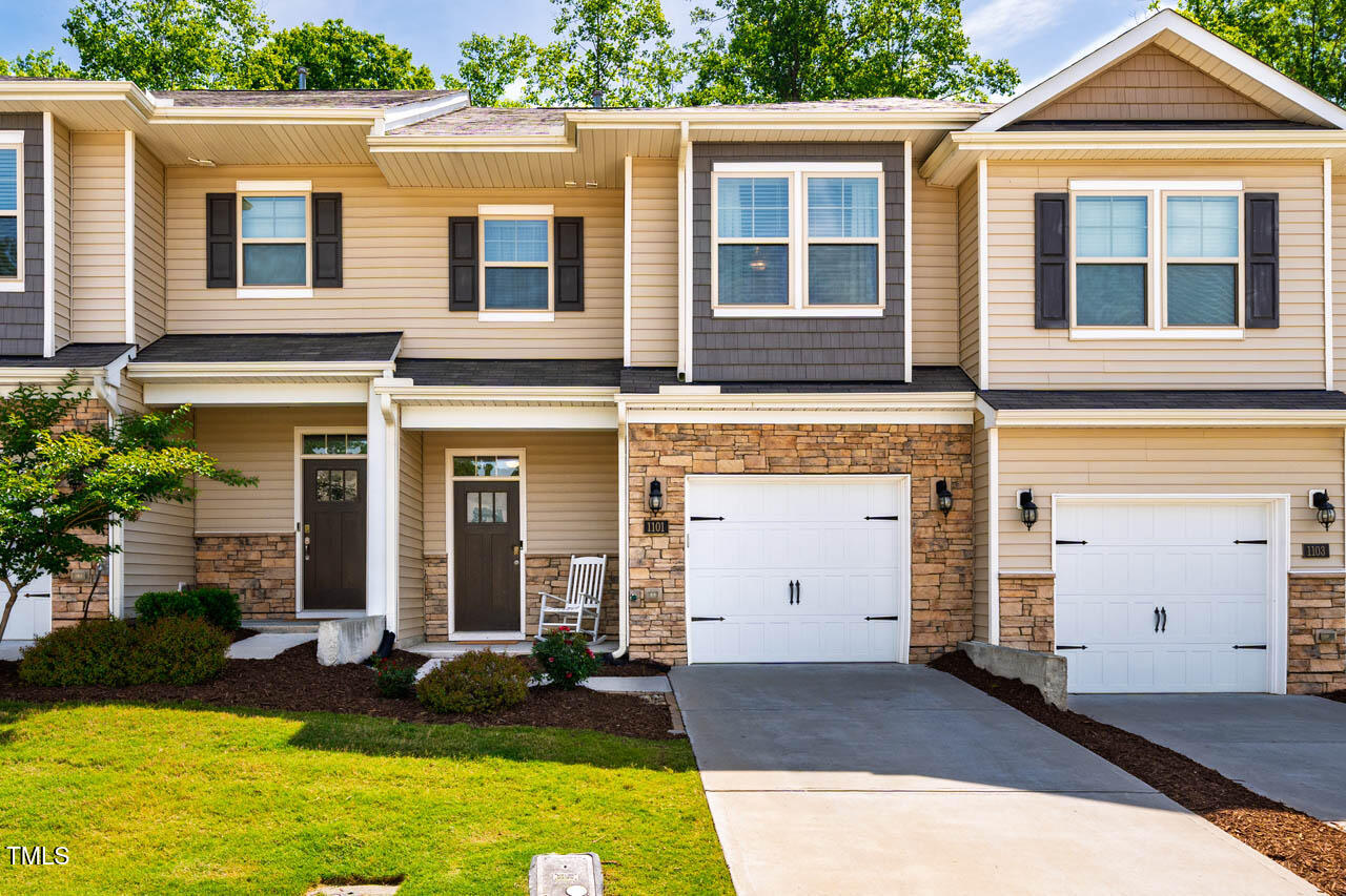 1101 Compass Drive Durham, NC 27713 - Photo 31 of 32 a view of a brick house with windows and yard