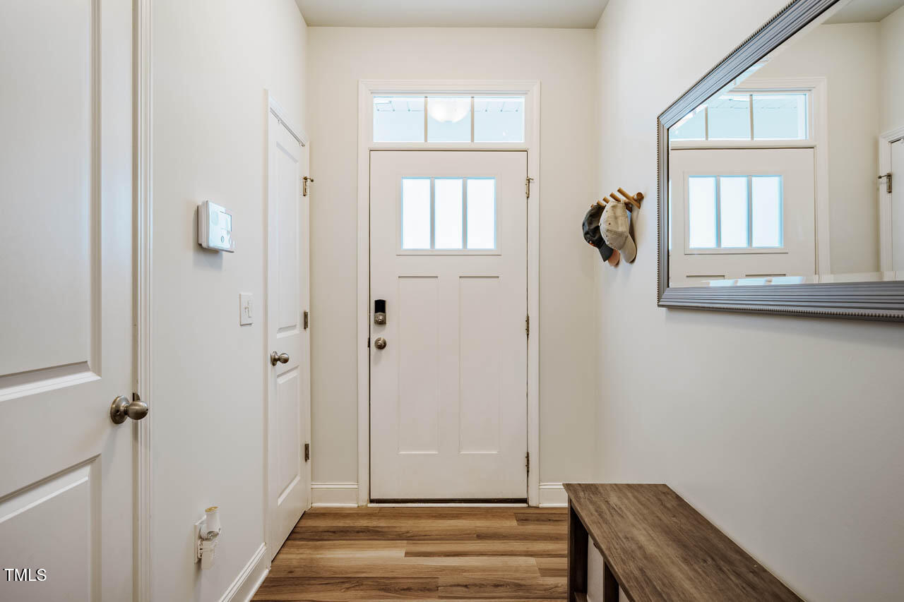 1101 Compass Drive Durham, NC 27713 - Photo 4 of 32 a view of a room with wooden floor and windows