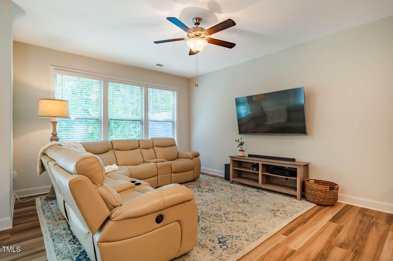 1101 Compass Drive Durham, NC 27713 - Photo 6 of 32 a living room with furniture and a flat screen tv